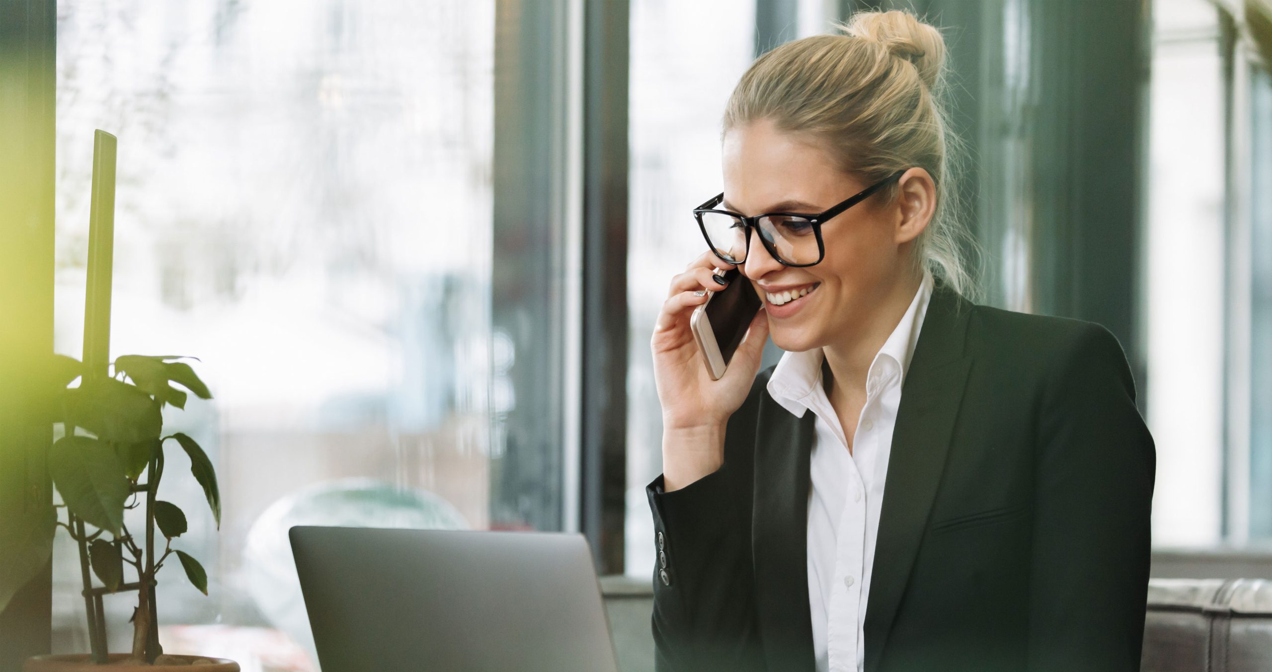 professional woman in business attire taking call on mobile